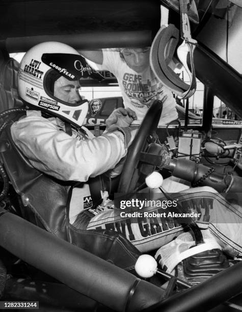 Driver Geoff Bodine sits in his racecar prior to the start of the 1985 Daytona 500 stock car race at Daytona International Speedway in Daytona Beach,...