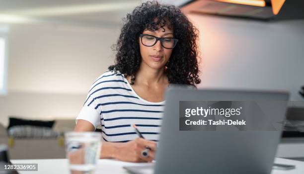 business woman working from home. freelancer workplace in living room with laptop - online course stock pictures, royalty-free photos & images