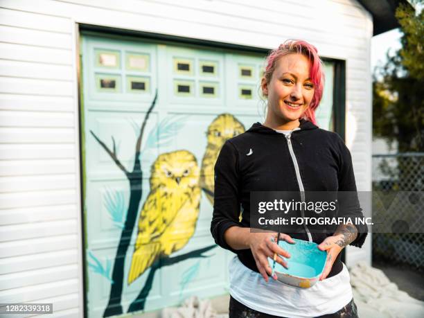 female mural artist at work - young woman painting wall stock pictures, royalty-free photos & images