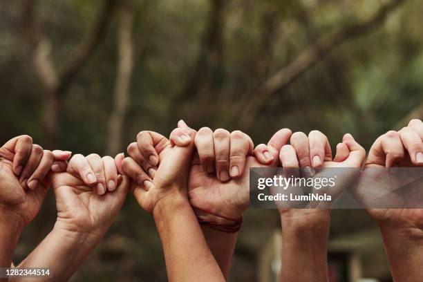 we’re all linked in this life - unity hands stock pictures, royalty-free photos & images