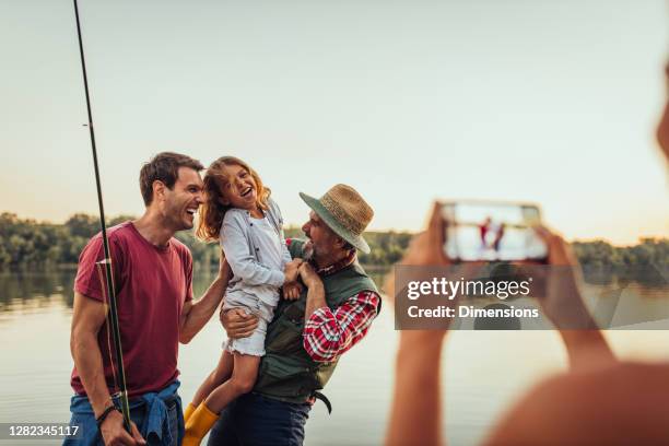 capturing family unforgettable moments - grandpa son stock pictures, royalty-free photos & images