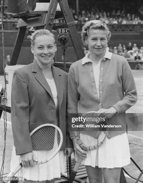 Darlene Hard of the United States and compatriot Louise Brough pose for photographs on Centre Court before their Women's Singles Semi Final match at...