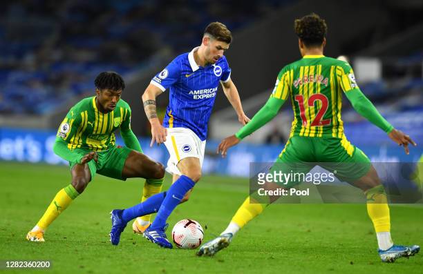 Pascal Gross of Brighton and Hove Albion is closed down by Matheus Pereira and Kyle Edwards of West Bromwich Albion during the Premier League match...