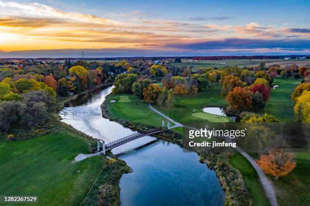 aerial grand river at dusk close to st. jacobs town in ontario, canada - ontario canada stock pictures, royalty-free photos & images