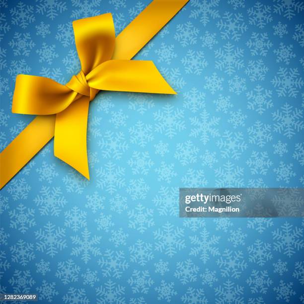 blue holiday background with snowflakes and yellow gift bow - present bow stock illustrations