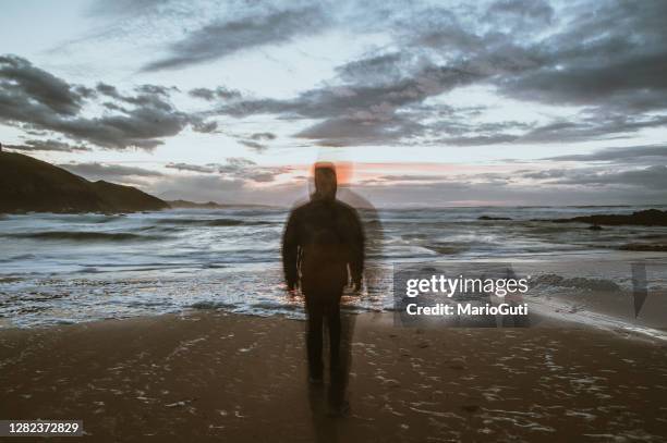 person in motion heading to the sea and disappearing - suicídio imagens e fotografias de stock