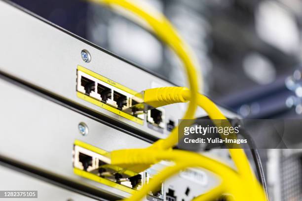 ethernet cables connected to server - cable modems stock pictures, royalty-free photos & images
