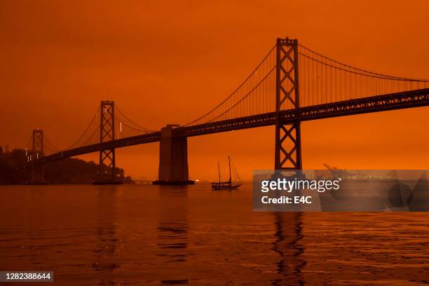 california's wildfires wrap the san francisco bay area in a dark orange haze - california fire stock pictures, royalty-free photos & images