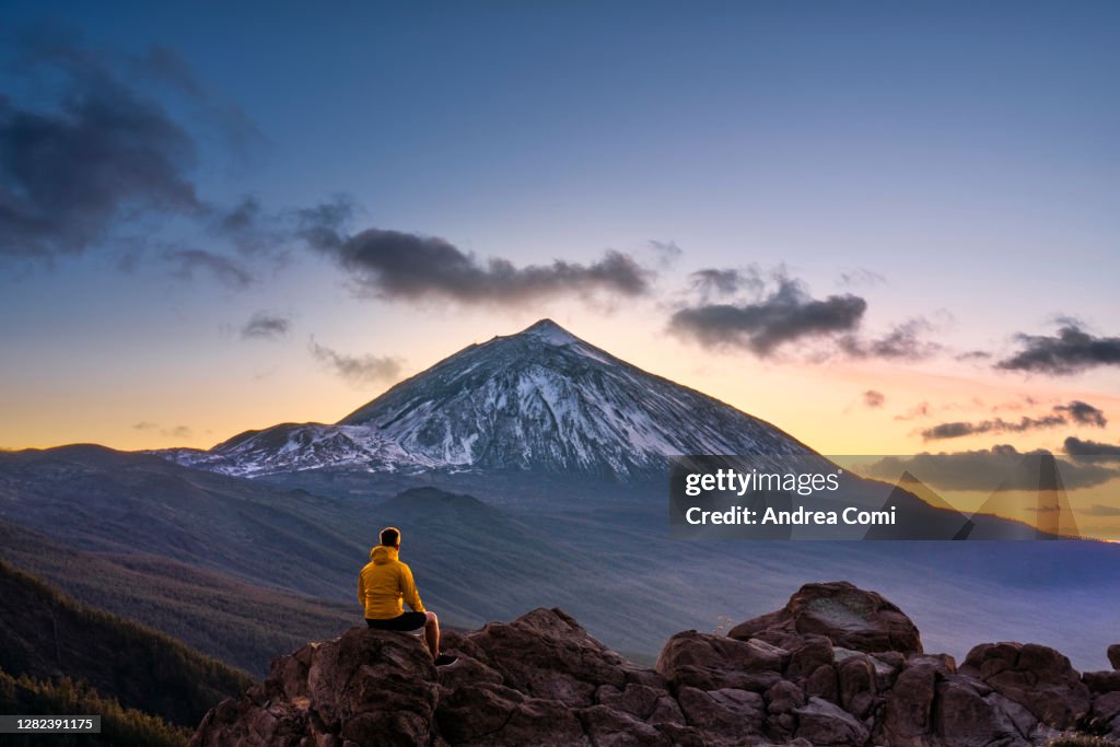 Man admiring the view of volcano Teide at dusk. Tenerife, Canary Islands, Spain