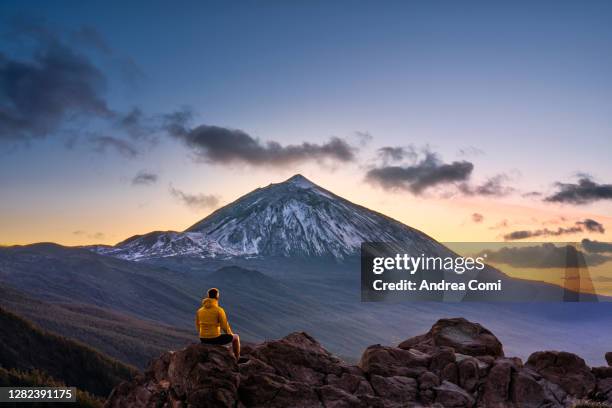 man admiring the view of volcano teide at dusk. tenerife, canary islands, spain - teneriffa bildbanksfoton och bilder