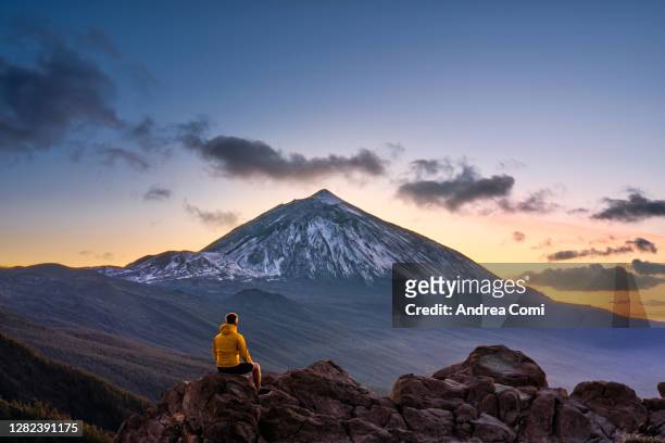 man admiring the view of volcano teide at dusk. tenerife, canary islands, spain - canary islands 個照片及圖片檔