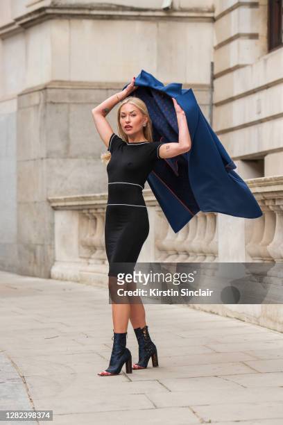 Influencer and model Lexi Fargo wears a Louis Vuitton coat, Orsay dress, Dior runway collection boots and Chanel earrings during LFW September 2020...