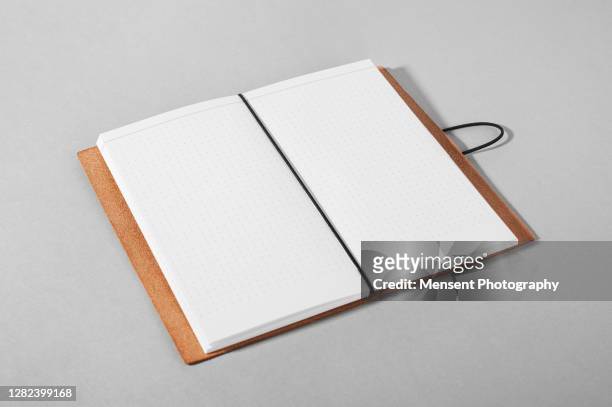 opened a blank magazine book on gray background - blank magazine ad stock-fotos und bilder