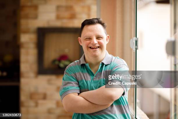 portrait of a man with special needs - down syndrome stock pictures, royalty-free photos & images