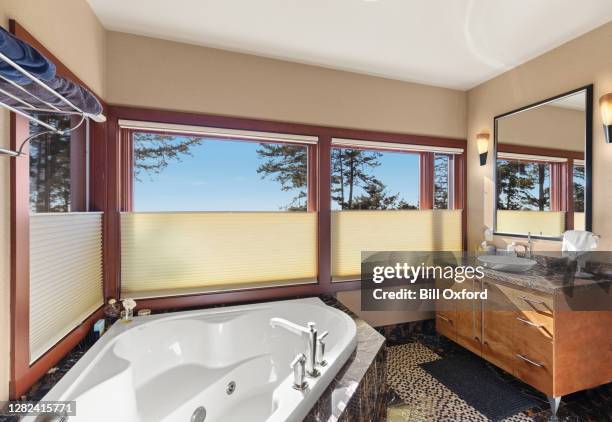 window treatments and blinds in bathroom by bathtub - pleated stock pictures, royalty-free photos & images
