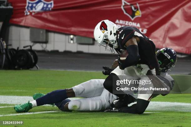 Strong safety Budda Baker of the Arizona Cardinals is tackled by wide receiver DK Metcalf of the Seattle Seahawks after an interception during the...