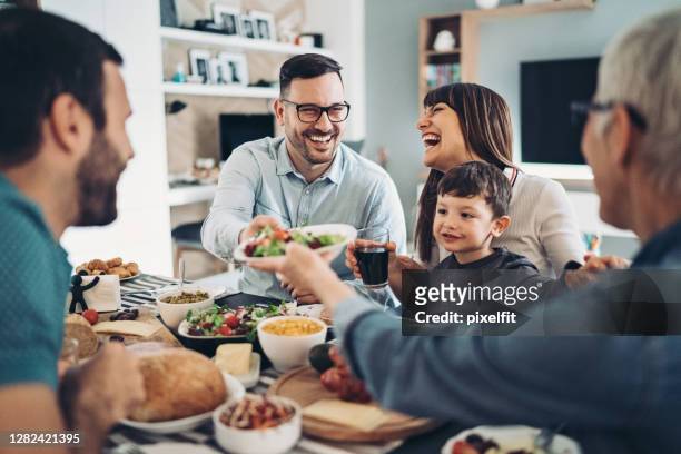 famiglia allargata mangiare insieme - tipo di cibo foto e immagini stock