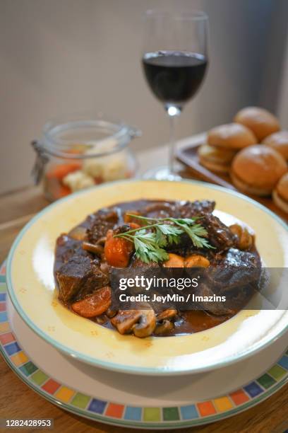 home-cooked beef bourguignon and wine - beef bourguignon stock pictures, royalty-free photos & images