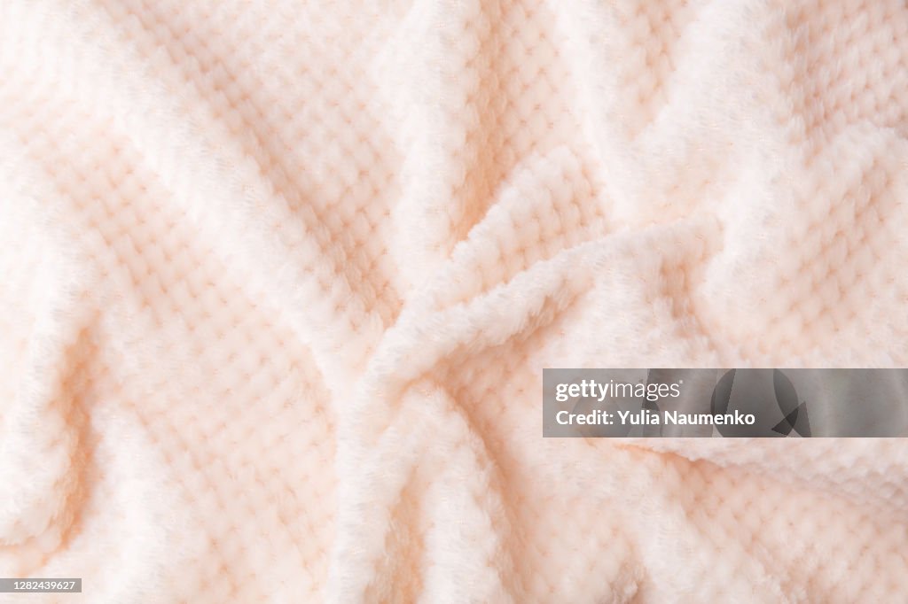 Soft plush fleece material with a lot of relief folds. Textil background.