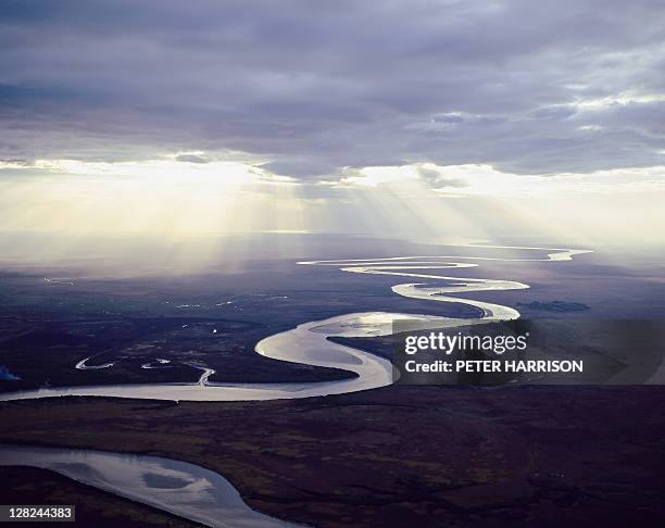 aerial view of east alligator river w/sunlight under clouds, kakadu, nt - río del este fotografías e imágenes de stock