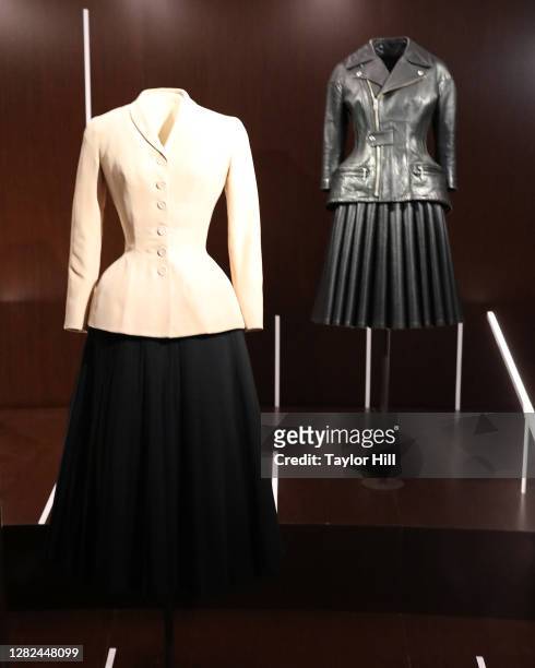 Christian Dior bar suit and a 2011 Junya Watanabe ensemble are on display at the press preview for the Costume Institute's annual exhibition "About...