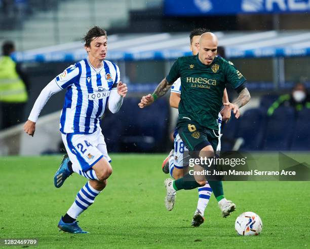 Robin Le Normand of Real Sociedad duels for the ball with Sandro Ramirez of SD Huesca during the La Liga Santander match between Real Sociedad and SD...