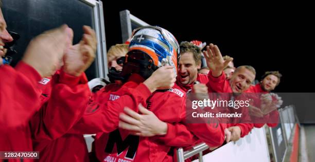 racing team celebrating victory - female racing driver stock pictures, royalty-free photos & images