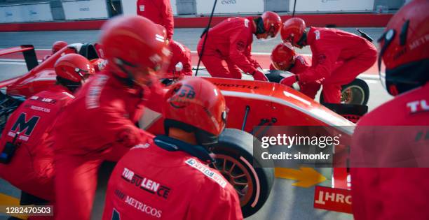 pit crew members working at pit stop - pit stop stock pictures, royalty-free photos & images