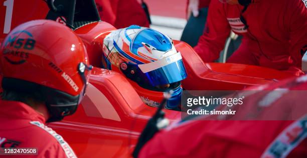 racing team working at pit stop - car racing stock pictures, royalty-free photos & images