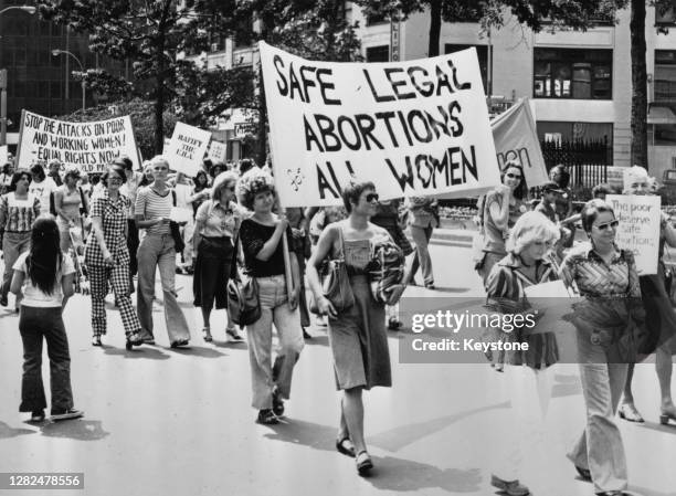 Women marching carrying a banner which reads 'Safe Legal Abortions for All Women' at a pro-choice demonstration in New York City, US, 1978.