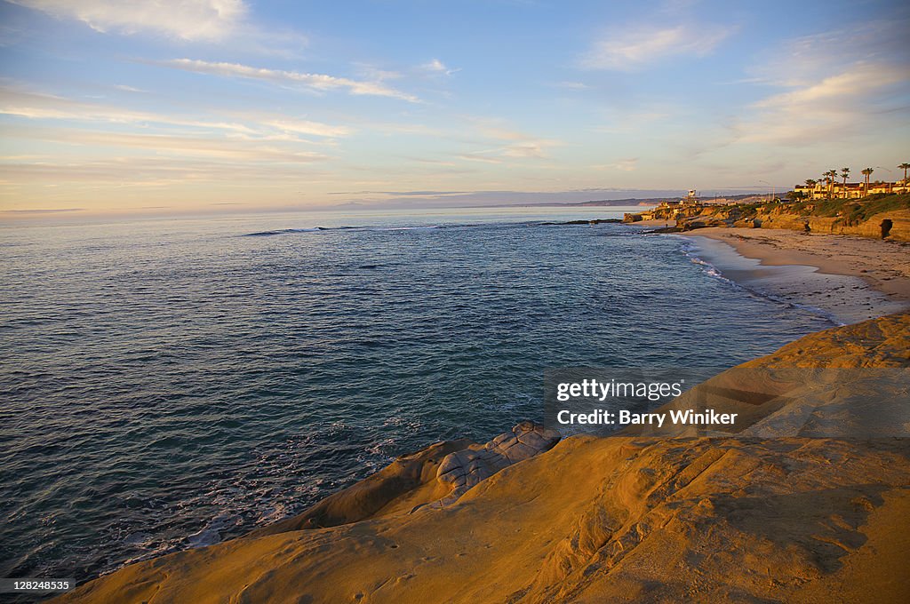 Pacific Ocean, coastal beach and rocky cliffs, La Jolla, California, at sunset