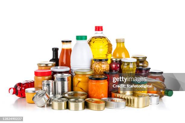 non-perishable food: canned goods, conserves, sauces and oils isolated on white background - tinned food stock pictures, royalty-free photos & images