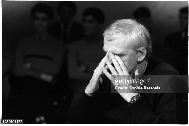 Czech writer Milan Kundera puts his hands to his face during an appearance on the French literary television show Apostrophes.
