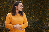 Portrait of beautiful happy woman in a yellow jumper