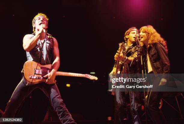 American Rock musician Bruce Springsteen plays guitar as he performs onstage with the E Street Band, during the 'Born in the USA' tour, at Brendan...