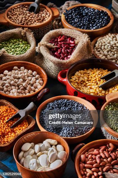 legumes and beans on a rustic wooden table with copy space - split pea stock pictures, royalty-free photos & images
