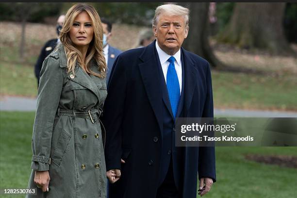 First Lady Melania Trump and President Donald Trump walk on the south lawn of the White House on October 27, 2020 in Washington, DC. President Trump...