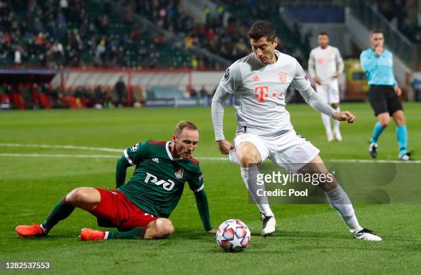 Robert Lewandowski of Bayern Munich is challenged by Vladislav Ignatyev of Lokomotiv Moscow during the UEFA Champions League Group A stage match...