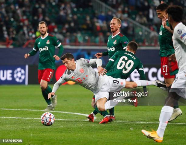 Robert Lewandowski of Bayern Munich is fouled by Daniil Kulikov of Lokomotiv Moscow leading to the awarding of a penalty which was later overturned...