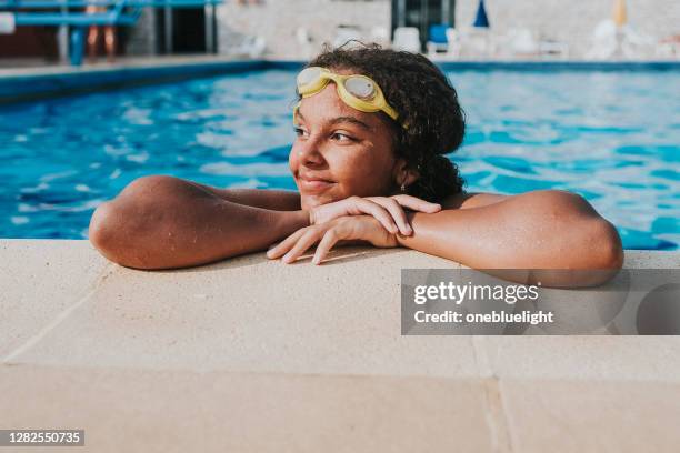 child (12-13) in swimming pool - lido stock pictures, royalty-free photos & images