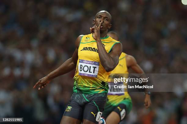 Usain Bolt of Jamaica celebrates as he crosses the finish line to claim victory and win gold during the Men's 200m Final on Day 13 of the London 2012...