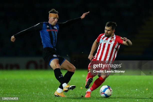 Jake Beesley of Rochdale makes a pass under pressure from Bailey Wright of Sunderland during the Sky Bet League One match between Rochdale and...