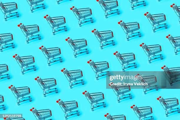shopping trolley pattern on blue background. - rollwagen stock-fotos und bilder