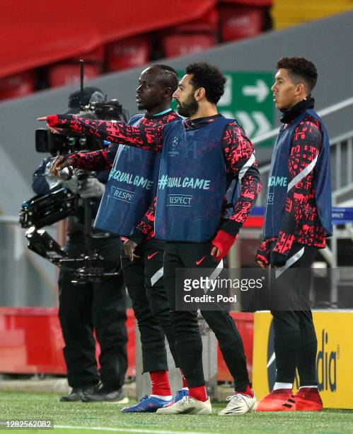 Sadio Mane, Mohammed Salah and Roberto Firmino of Liverpool watch on from the sideline during the UEFA Champions League Group D stage match between...