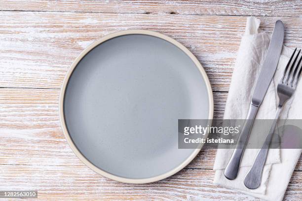 empty ceramic plate on rural wooden background - rustic plate overhead stock pictures, royalty-free photos & images