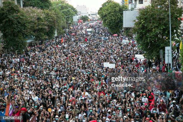 crowds of protesters march in bangkok, thailand - demonstration stock pictures, royalty-free photos & images