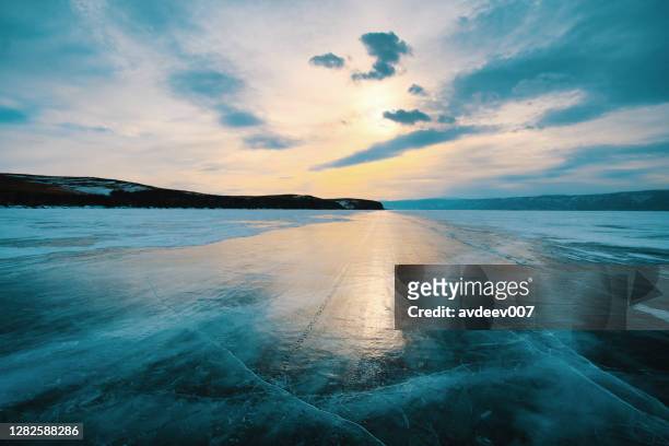 russia siberia lake baikal road on ice to olkhon island - frozen lake sunset stock pictures, royalty-free photos & images