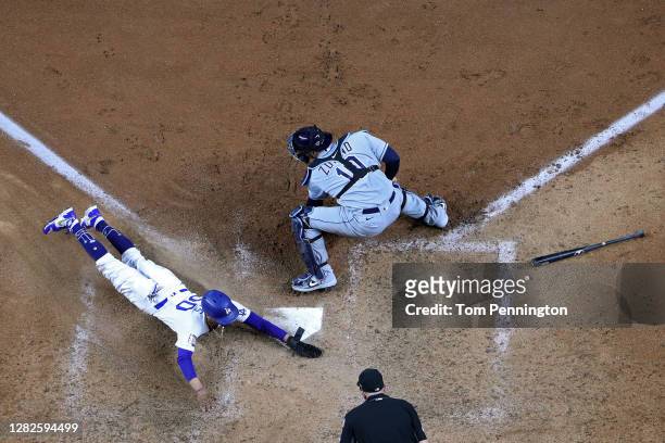 Mookie Betts of the Los Angeles Dodgers slides in safely past Mike Zunino of the Tampa Bay Rays to score a run on a fielders choice hit by Corey...