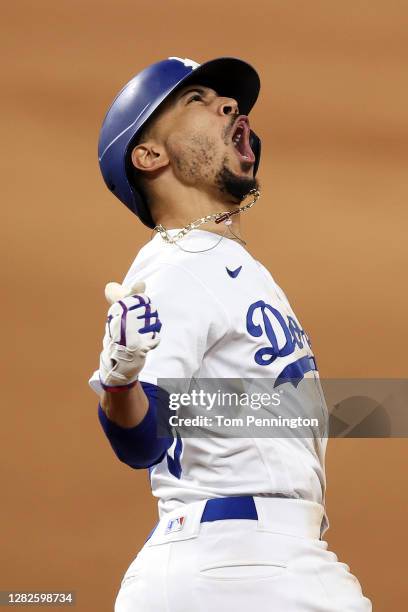 Mookie Betts of the Los Angeles Dodgers celebrates as he rounds the bases after hitting a solo home run against the Tampa Bay Rays during the eighth...