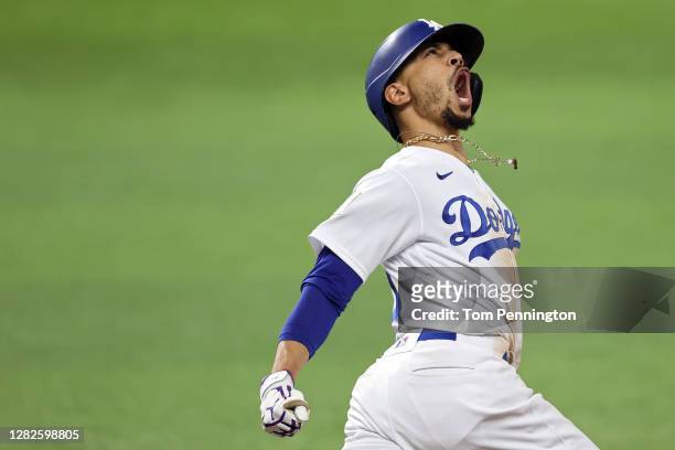 Mookie Betts of the Los Angeles Dodgers celebrates as he rounds the bases after hitting a solo home run against the Tampa Bay Rays during the eighth...